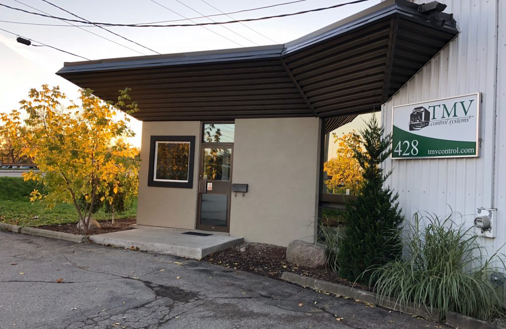 Front entrance with TMV logo and sunrise