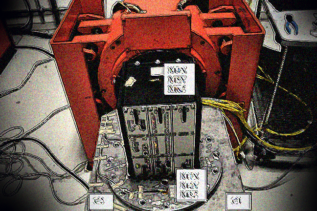 TECU attached to a big red vibration machine to test the strength of the electronic connections under shock and vibration