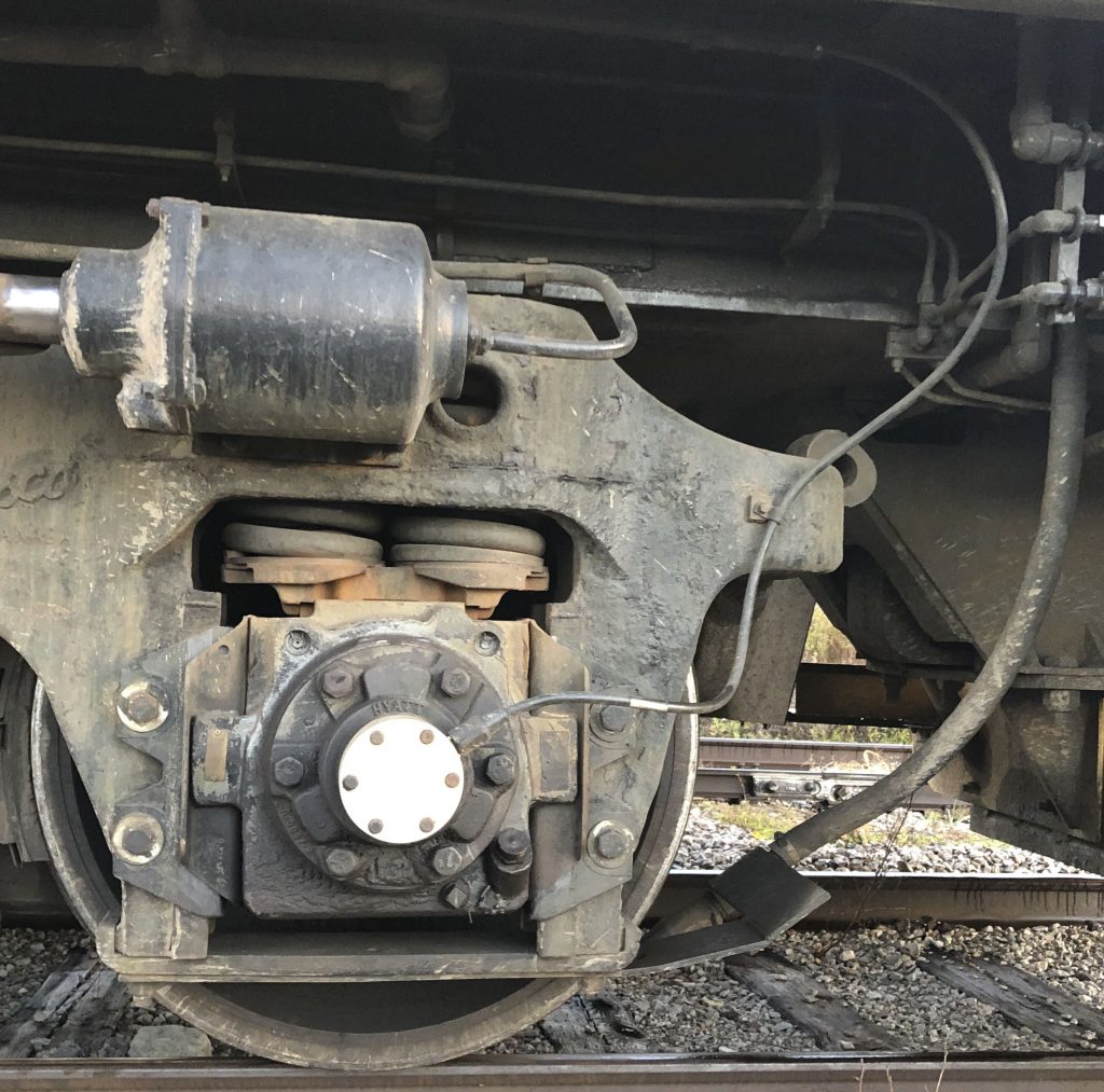 Installed TMV axle generator in the axle of a large locomotive, with cable routed to main electrical cabinet inside the locomotive for accurate speed sensing